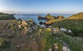 Beauitful sunrise and sunset landscape image of Kynance Cove in Cornwall England with colourful sky Royalty Free Stock Photo