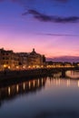 Stunning sunset is beginning to set in the sky above a tranquil body of water in Florence.