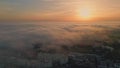 Stunning sunset cloudy town aerial view. Golden sunlight illuminating cozy city