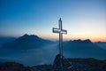 Stunning sunset with cross on top of mountain peak Switzerland Royalty Free Stock Photo