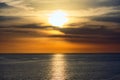 Stunning sunset in a dramatic sky above a serene ocean Royalty Free Stock Photo