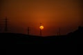 Stunning sunset illuminating a vast array of power towers and electrical wires