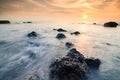 Stunning sunset moment seascape,soft wave hitting the rock over cloudy sky Royalty Free Stock Photo