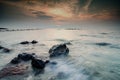 Stunning sunset moment seascape,soft wave hitting the rock over cloudy sky Royalty Free Stock Photo