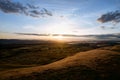 Stunning sunset over and grassy plains against a cloudy sky Royalty Free Stock Photo