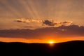Stunning sunset over hills with dramatic clouds. Royalty Free Stock Photo