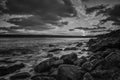 Sunset over the sea with the rocky sea coast in black and white Royalty Free Stock Photo