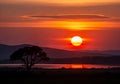 A stunning sunset scene featuring a large, vibrant sun setting Royalty Free Stock Photo
