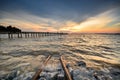 Stunning sunset scenery at seascape. Long jetty background.