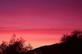 Stunning sunset sky with gradient purple afterglow over the silhouette of mountainside Royalty Free Stock Photo