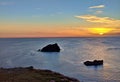 A beautiful sunset on the coast of Cornwall by the calm sea Royalty Free Stock Photo