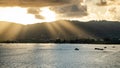 Stunning sunset with sun rays through clouds at Chalong Bay