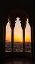 Stunning Sunset View Through Ornate Arched Window Overlooking Cityscape Royalty Free Stock Photo