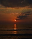 Stunning sunset view over the sea, sun shining in dark evening Royalty Free Stock Photo