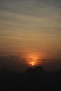 Stunning sunset view of a silhouetted tree line against a cloudy sky Royalty Free Stock Photo