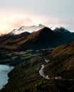 Stunning sunset view of snow-capped Lake Wakatipu Mount and a road on mountain slope in New Zealand Royalty Free Stock Photo