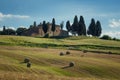 Stunning Tuscany landscape, typical stone house and hay bale on the hills,near Val d`Orcia, Italy, Europe Royalty Free Stock Photo