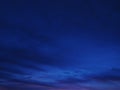 Stunning twilight sky, deep blue hues with subtle cloud formations. Perfect for backgrounds, website headers, or moodsetting Royalty Free Stock Photo