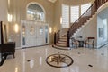 Stunning two story entry foyer with marble mosaic tiled floor Royalty Free Stock Photo