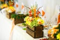 stunning unusual decorated centerpiece table with orange and yellow flowers for a wedding in the restaurant Royalty Free Stock Photo