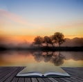 Stunning vibrant Autumn foggy sunrise English countryside landscape image coming out of pages of book