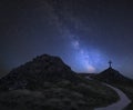 Vibrant Milky Way composite image over landscape of Ynys Llanddwyn Island with Twr Mawr lighthouse in background