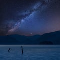 Stunning vibrant Milky Way composite landscape image over Derwent Water in Lake District during Autumn Fall sunrise with soft Royalty Free Stock Photo