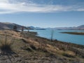 View of Lake Tekapo, New Zealand, with turquoise blue water and cloud Royalty Free Stock Photo