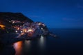 Stunning view of the beautiful and cozy village of Manarola in the Cinque Terre National Park at night. Liguria, Italy. Royalty Free Stock Photo