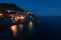 Stunning view of the beautiful and cozy village of Manarola in the Cinque Terre National Park at night. Liguria, Italy. Royalty Free Stock Photo