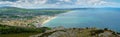 Stunning view of Bray bay from cross top mountains. Cloudy sky, blue weather and green grass