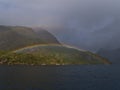 Colorful double rainbow on the coast of AustvÃÂ¥gÃÂ¸ya, Lofoten, Norway on Raftsundet strait with rugged mountains. Royalty Free Stock Photo