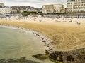 Stunning view of Dinard beach with historical villas and traditional blue-white striped huts, Atlantic coast of Brittany, France Royalty Free Stock Photo