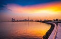 Stunning view of Dubai city skyline at sunset with a colorful sky and reflection on the water. Royalty Free Stock Photo