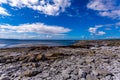 Stunning view of the empty limestone rocky beach of the island of Inis Oirr with the Atlantic Ocean in the background