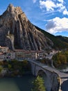 Stunning view of famous mountain Rocher de la Baume in village Sisteron, Provence, France in autumn with bridge and old houses. Royalty Free Stock Photo