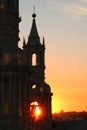 Stunning view of golden setting sunlight shining through bell tower of Basilica Cathedral of Arequipa