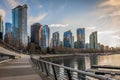 Beautiful downtown buildings and boats in Harbour of Vancouver at sunset, traveling tourists walking on promenade Royalty Free Stock Photo