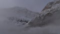 View of Mount Edith Cavell on foggy morning with snow-covered steep rock face and Angel Glacier in Jasper National Park, Canada. Royalty Free Stock Photo