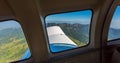 Stunning view of mountain range from a window of a small airplane during take off. Air travel in Fiji, Melanesia, Oceania.