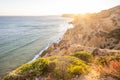 Stunning view over Praia do Camilo in Lagos, Algarve Portugal during the sunrise. Rocks, cliffs and formations in the ocean.