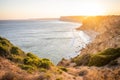 Stunning view over Praia do Camilo in Lagos, Algarve Portugal during the sunrise. Rocks, cliffs and formations in the ocean.