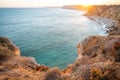 Stunning view over Praia do Camilo in Lagos, Algarve Portugal during the sunrise. Rocks, cliffs and formations in the ocean.