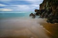 Stunning view of rocky coastal cliffs and the sea under a cloudy blue sky Royalty Free Stock Photo