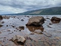 Stunning view of a serene lake surrounded by large rocks Royalty Free Stock Photo