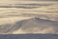 Stunning view of the ski station on the mountain in the middle of the clouds below Royalty Free Stock Photo