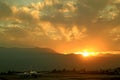 Stunning view of sunrise over the mountain ranges with the airport runway in the foreground Royalty Free Stock Photo