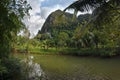 Stunning view to the karst formation hills, river with fish and Royalty Free Stock Photo