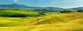 Stunning view of fields and farmlands with small villages on the horizon. Summer rural landscape of rolling hills, curved roads