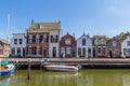 Stunning views over historic dutch yacht harbour with classic dutch historical houses and bike riders